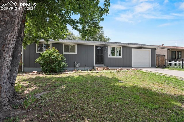 ranch-style house with a garage and a front yard