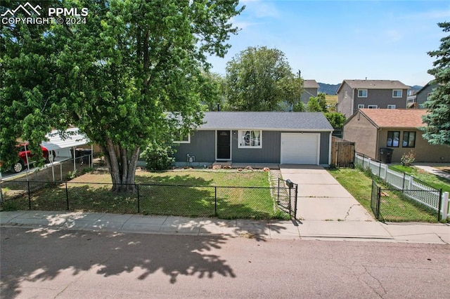 view of front facade with a garage and a front lawn