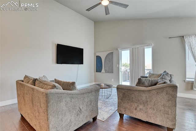 living room with dark hardwood / wood-style floors, ceiling fan, and lofted ceiling