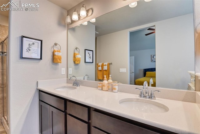 bathroom featuring ceiling fan, vanity, and walk in shower