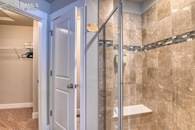 bathroom with a shower with door