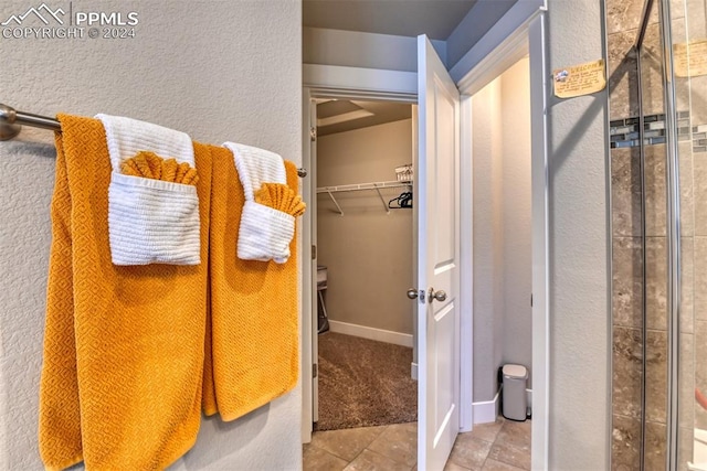 bathroom with tile patterned flooring and an enclosed shower