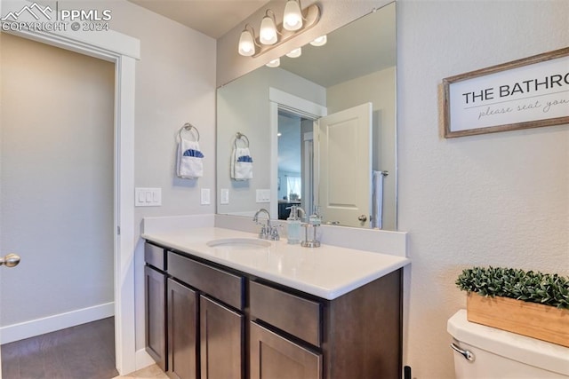 bathroom featuring hardwood / wood-style floors, vanity, and toilet