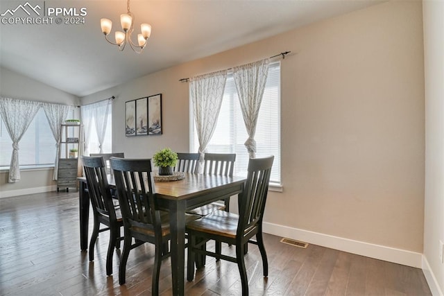 dining space with a chandelier, dark hardwood / wood-style floors, plenty of natural light, and lofted ceiling