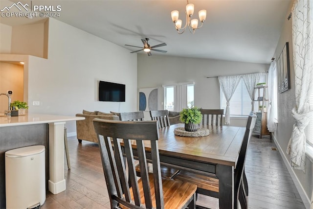 dining space featuring ceiling fan with notable chandelier, lofted ceiling, and hardwood / wood-style flooring