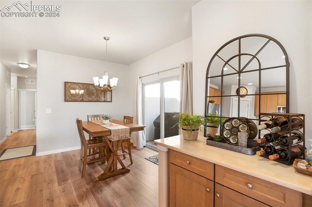 dining room with a notable chandelier and light hardwood / wood-style flooring