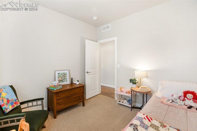 bedroom with light carpet