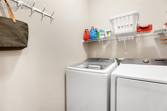 laundry area featuring washing machine and clothes dryer