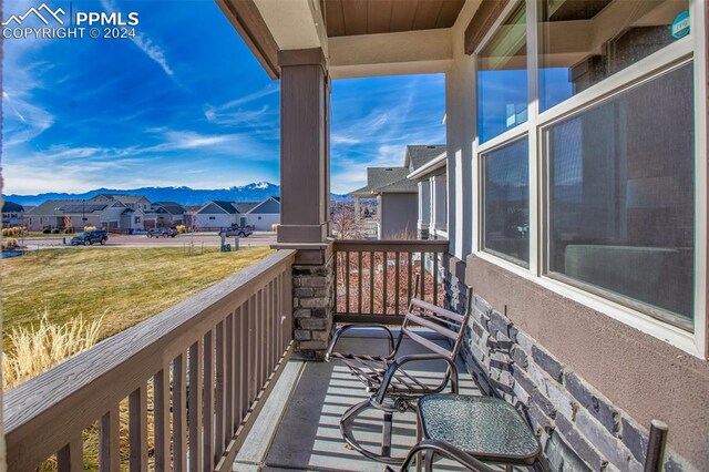 balcony with a mountain view and covered porch