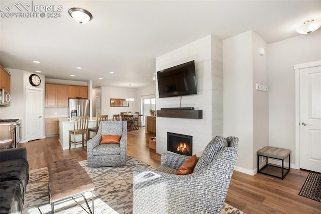 living room with hardwood / wood-style floors and a fireplace