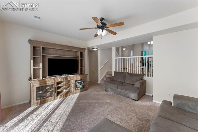 carpeted living room featuring ceiling fan