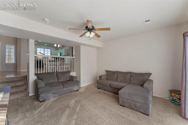 carpeted living room with ceiling fan