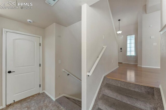 staircase with hardwood / wood-style floors