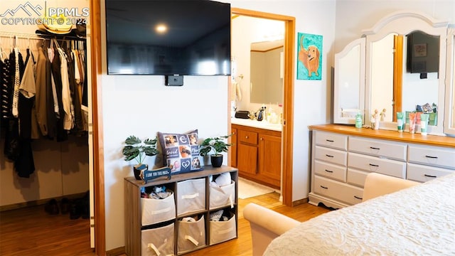 920 E 14th St, La Junta, CO 81050 - bedroom with connected bathroom and light hardwood / wood-style floors