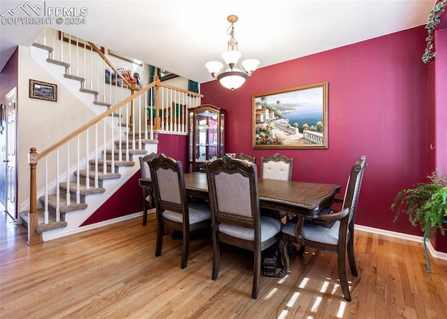 dining area with a chandelier and wood-type flooring