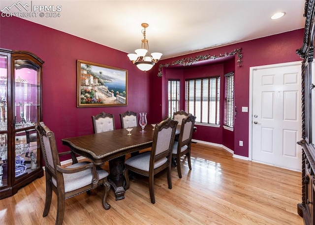 dining space featuring an inviting chandelier and light wood-type flooring