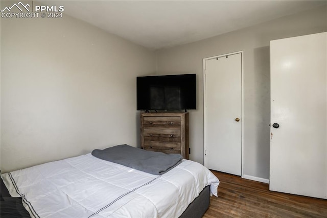 bedroom with dark hardwood / wood-style flooring