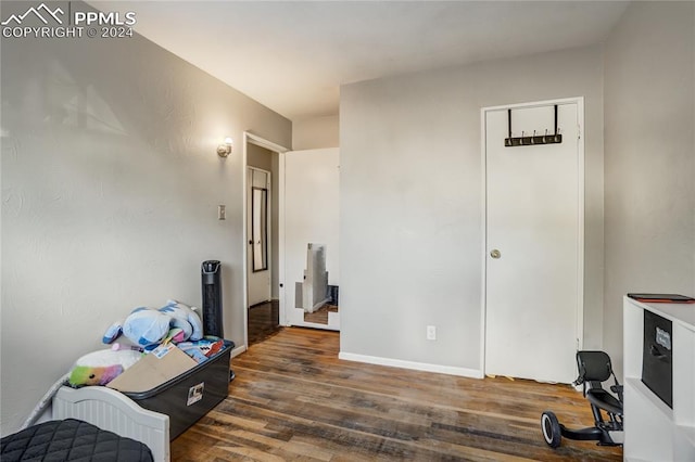 bedroom with dark hardwood / wood-style flooring