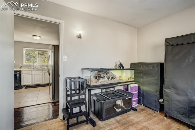 misc room with sink and light hardwood / wood-style flooring