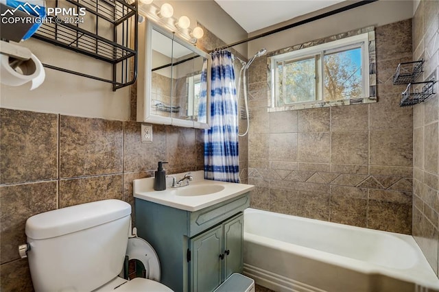 full bathroom featuring vanity, toilet, shower / bathtub combination with curtain, and tile walls