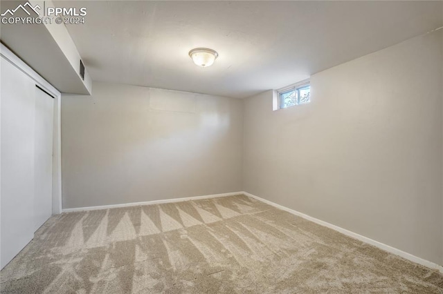 basement featuring light colored carpet