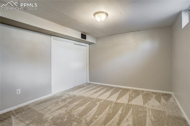 unfurnished bedroom featuring a closet and carpet floors