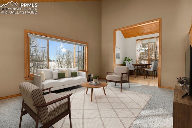 living room featuring light carpet, high vaulted ceiling, and a chandelier