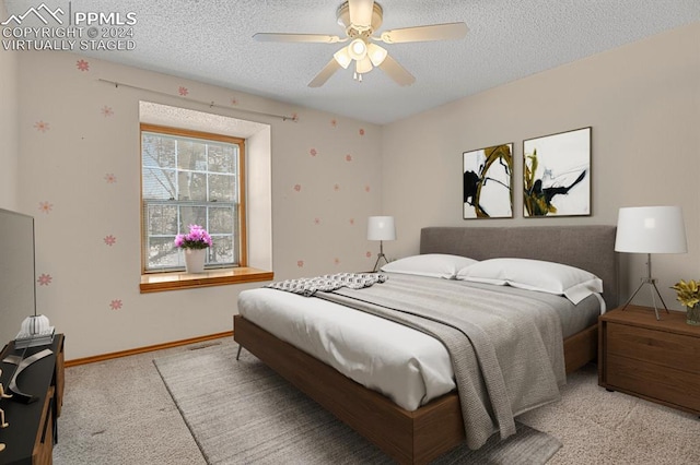 carpeted bedroom with a textured ceiling and ceiling fan