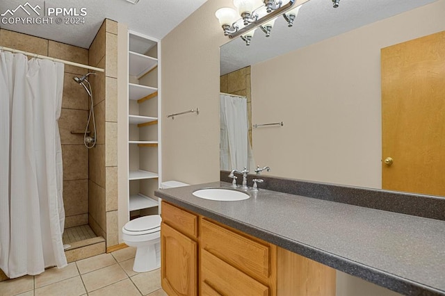 bathroom with tile patterned floors, vanity, walk in shower, and toilet