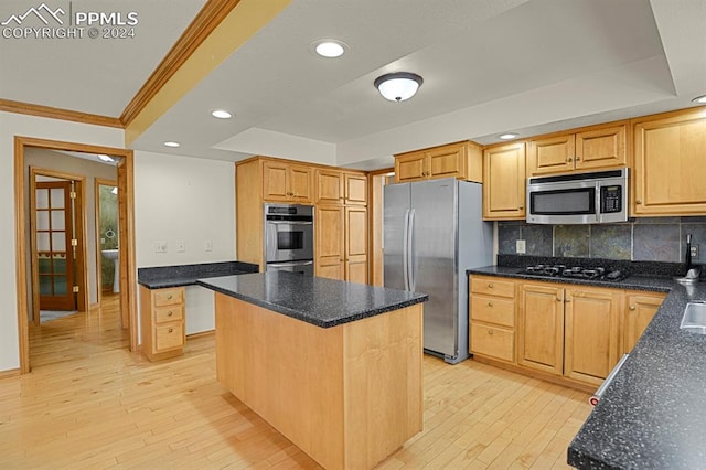 kitchen featuring tasteful backsplash, light hardwood / wood-style flooring, a center island, and appliances with stainless steel finishes