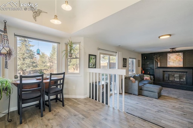 dining room with hardwood / wood-style floors and a fireplace