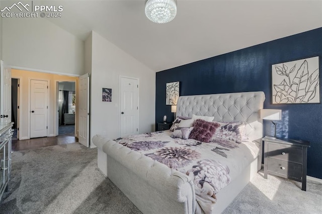 bedroom with carpet flooring and high vaulted ceiling