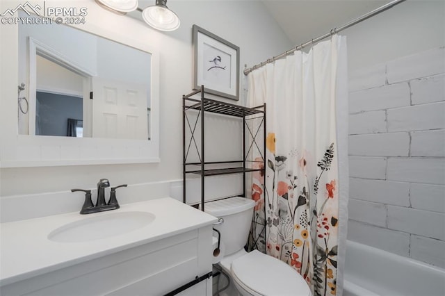 full bathroom with vanity, toilet, and shower / tub combo