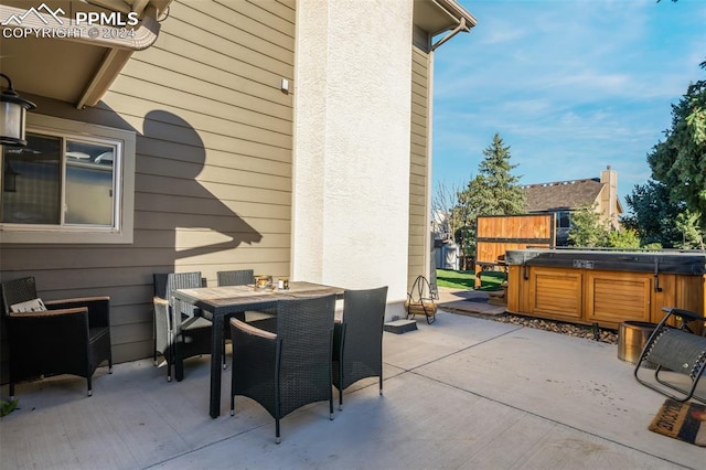 view of patio / terrace with a hot tub