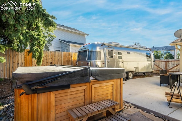 wooden deck with a patio area and a hot tub