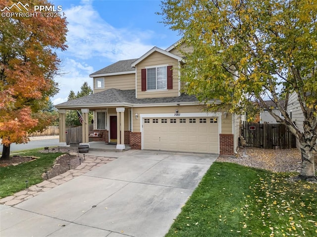 view of front of property with a porch and a garage