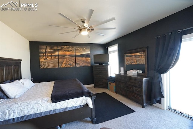 bedroom with ceiling fan and light carpet