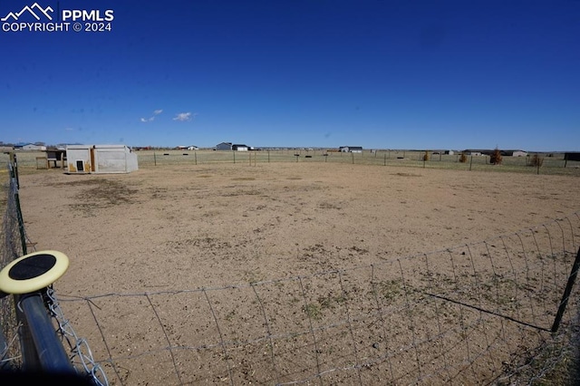 view of yard with a rural view