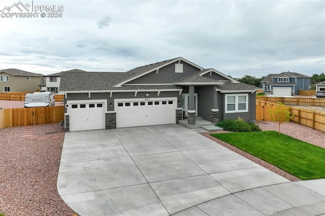 view of front facade with a front yard and a garage