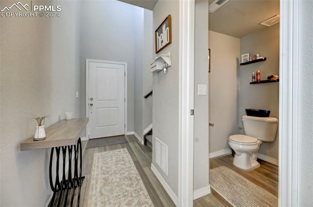 interior space with wood-type flooring and toilet