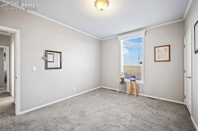 carpeted spare room featuring ornamental molding