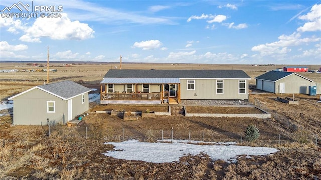 back of property with a rural view