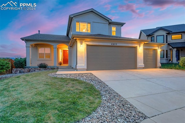 view of front of property with a lawn and a garage