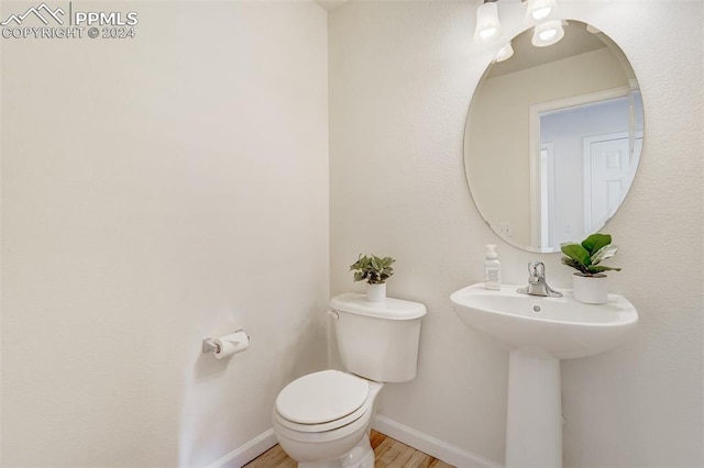 bathroom featuring hardwood / wood-style floors, toilet, and sink