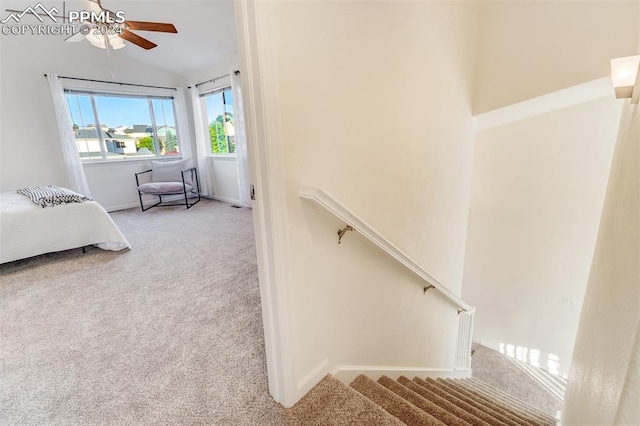 unfurnished bedroom featuring ceiling fan, light carpet, and high vaulted ceiling