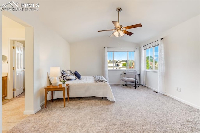 carpeted bedroom featuring ceiling fan and vaulted ceiling