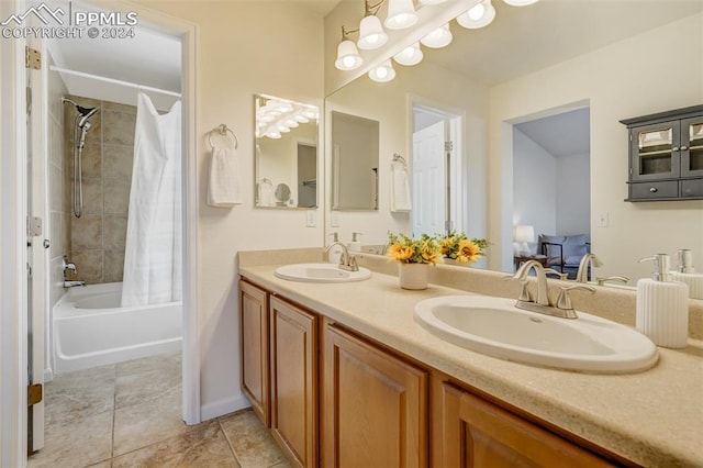 bathroom featuring tile patterned floors, shower / bath combo with shower curtain, and vanity