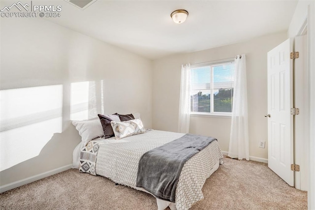 bedroom with light colored carpet