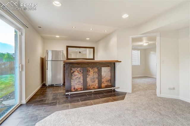 unfurnished living room with dark carpet