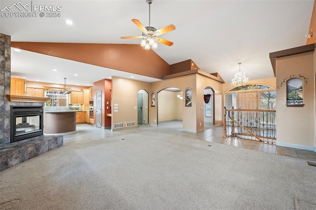 living room featuring a tile fireplace, ceiling fan with notable chandelier, high vaulted ceiling, and light tile patterned flooring